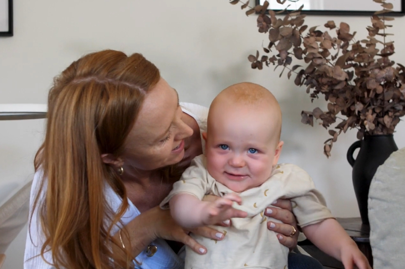 Happy woman with a baby after successfully being helped by IVF at Genea